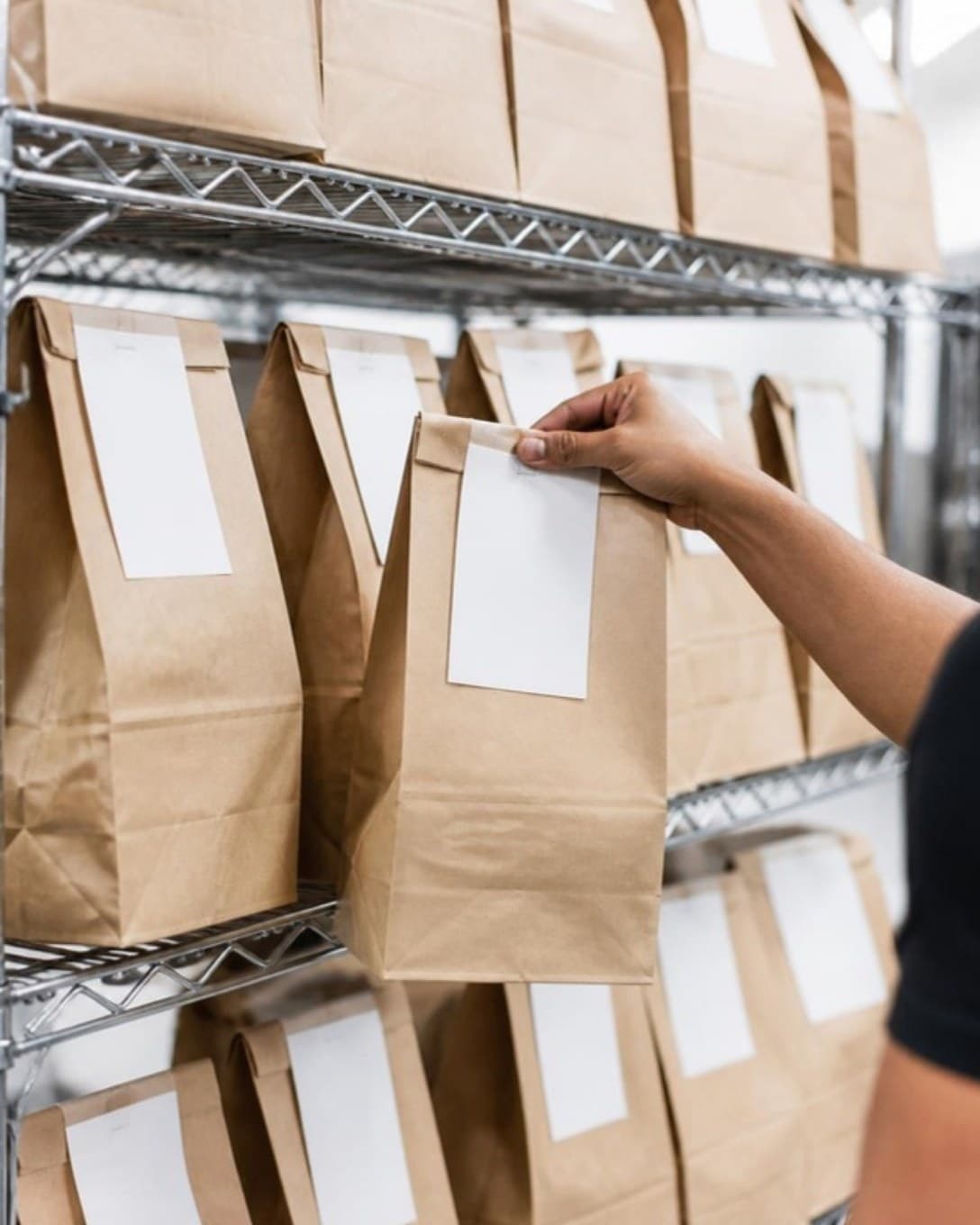 Packed delivery bags on a dispatch shelf