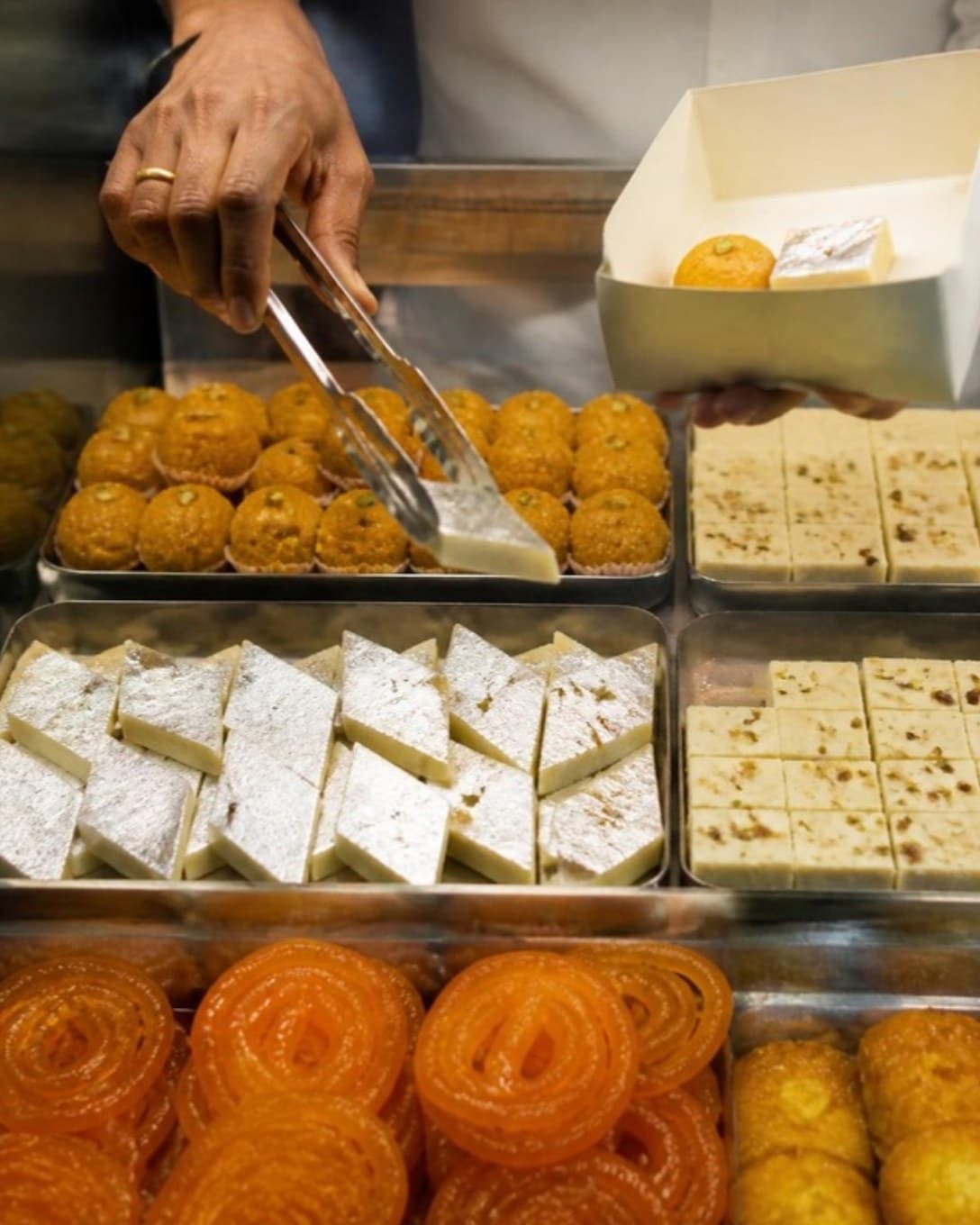 Sweets picked from a display into a box