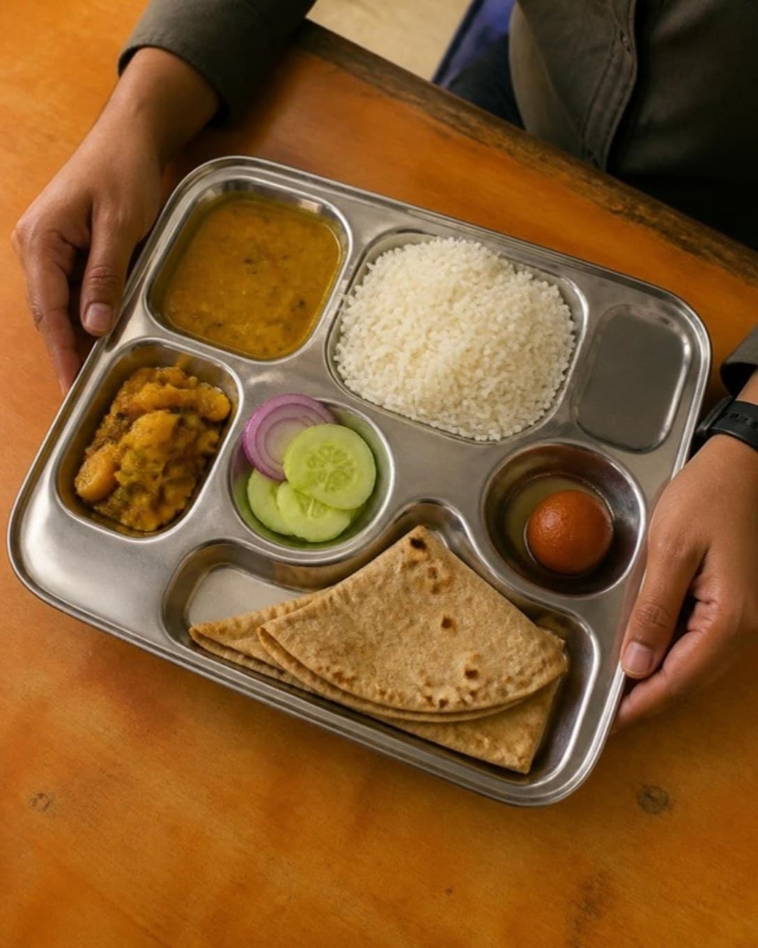 Steel meal tray with rice, dal, sabzi and roti